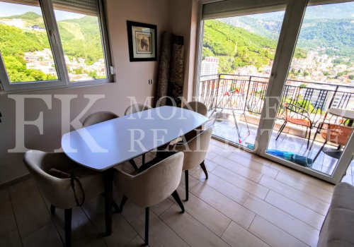 Reduced price. Apartment with open gallery, in Budva, 78 m2, overlooking the city and the surrounding mountains, in Montenegro.