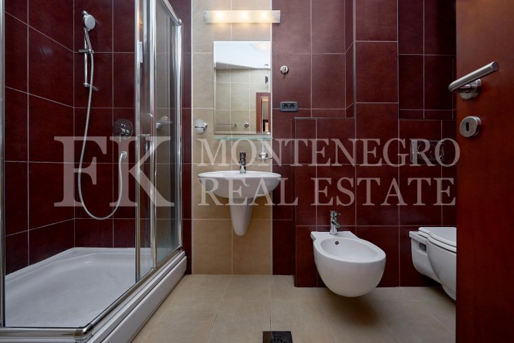 Excellent furnished apartment in the center of Budva, 116m2, with underground parking, in close proximity to the sea, in Montenegro.