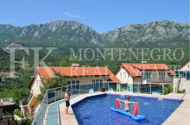 Semi-detached house, 132m2, above Bar, in a beautiful complex of villas in the village area Zupci, with sea view, swimming pool plus two garages, in Montenegro.