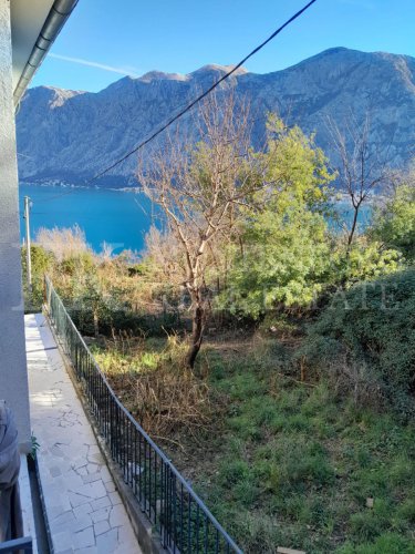 This newly built house with 143 sqm and an additional guesthouse (51 sqm) offers a prime location, just 330 meters from the coast, with an impressive panoramic view of the Bay of Kotor and the surrounding mountains.