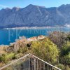This newly built house with 143 sqm and an additional guesthouse (51 sqm) offers a prime location, just 330 meters from the coast, with an impressive panoramic view of the Bay of Kotor and the surrounding mountains.