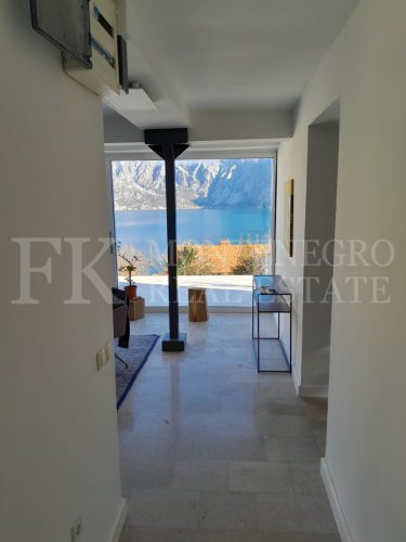 This newly built house with 143 sqm and an additional guesthouse (51 sqm) offers a prime location, just 330 meters from the coast, with an impressive panoramic view of the Bay of Kotor and the surrounding mountains.