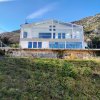 This newly built house with 143 sqm and an additional guesthouse (51 sqm) offers a prime location, just 330 meters from the coast, with an impressive panoramic view of the Bay of Kotor and the surrounding mountains.