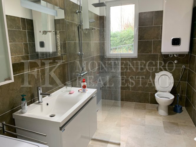 This newly built house with 143 sqm and an additional guesthouse (51 sqm) offers a prime location, just 330 meters from the coast, with an impressive panoramic view of the Bay of Kotor and the surrounding mountains.