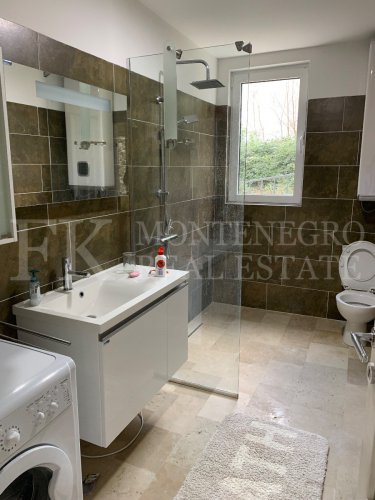 This newly built house with 143 sqm and an additional guesthouse (51 sqm) offers a prime location, just 330 meters from the coast, with an impressive panoramic view of the Bay of Kotor and the surrounding mountains.